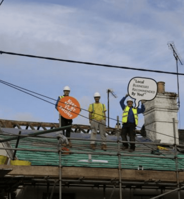 The LA Roofing team on a roof, recommended by local businesses
