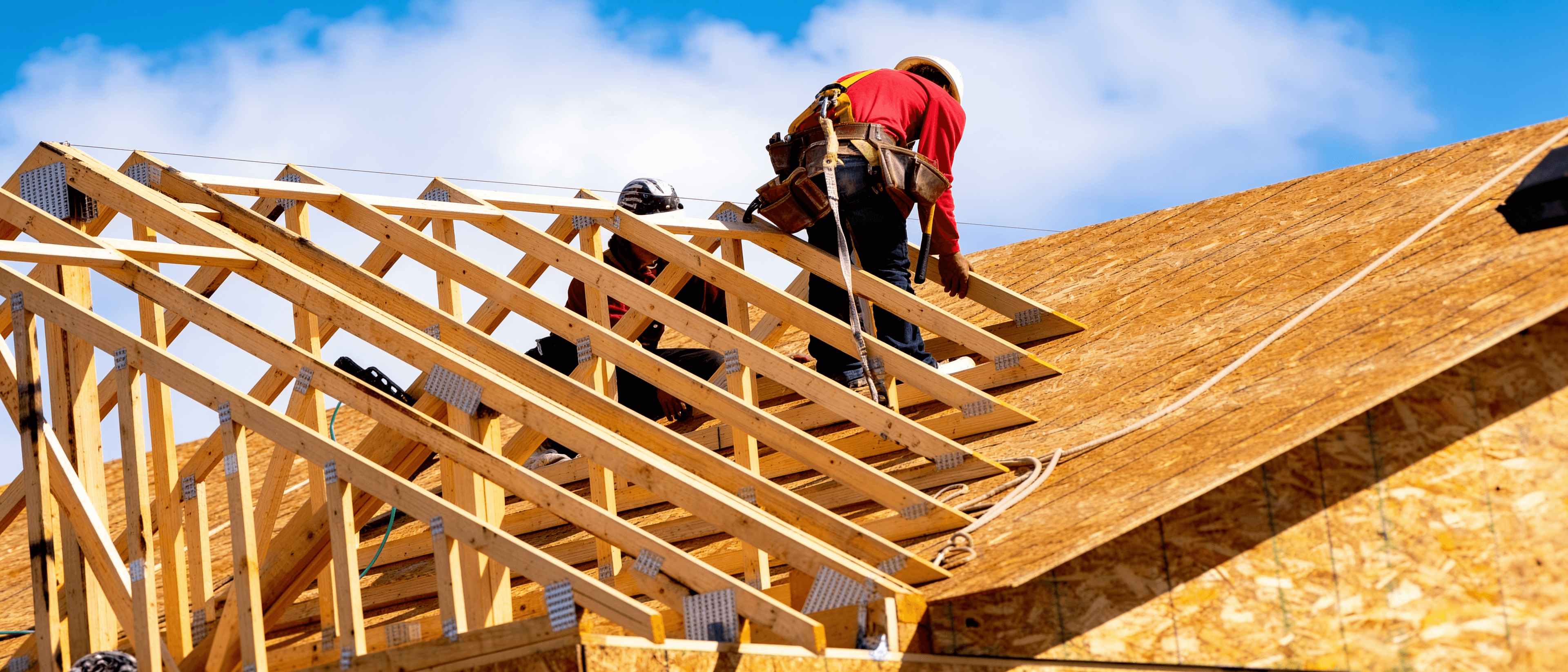 Roofers working on a timber roof frame